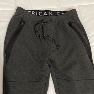 American Eagle Men’s Joggers, Charcoal Gray in color, zip pockets 2 front 1 back